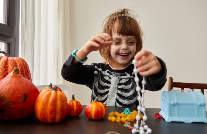 Happy child dressing up with decorations before halloween holiday