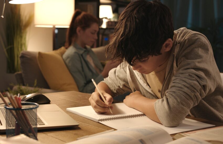 Student doing his homework at home
