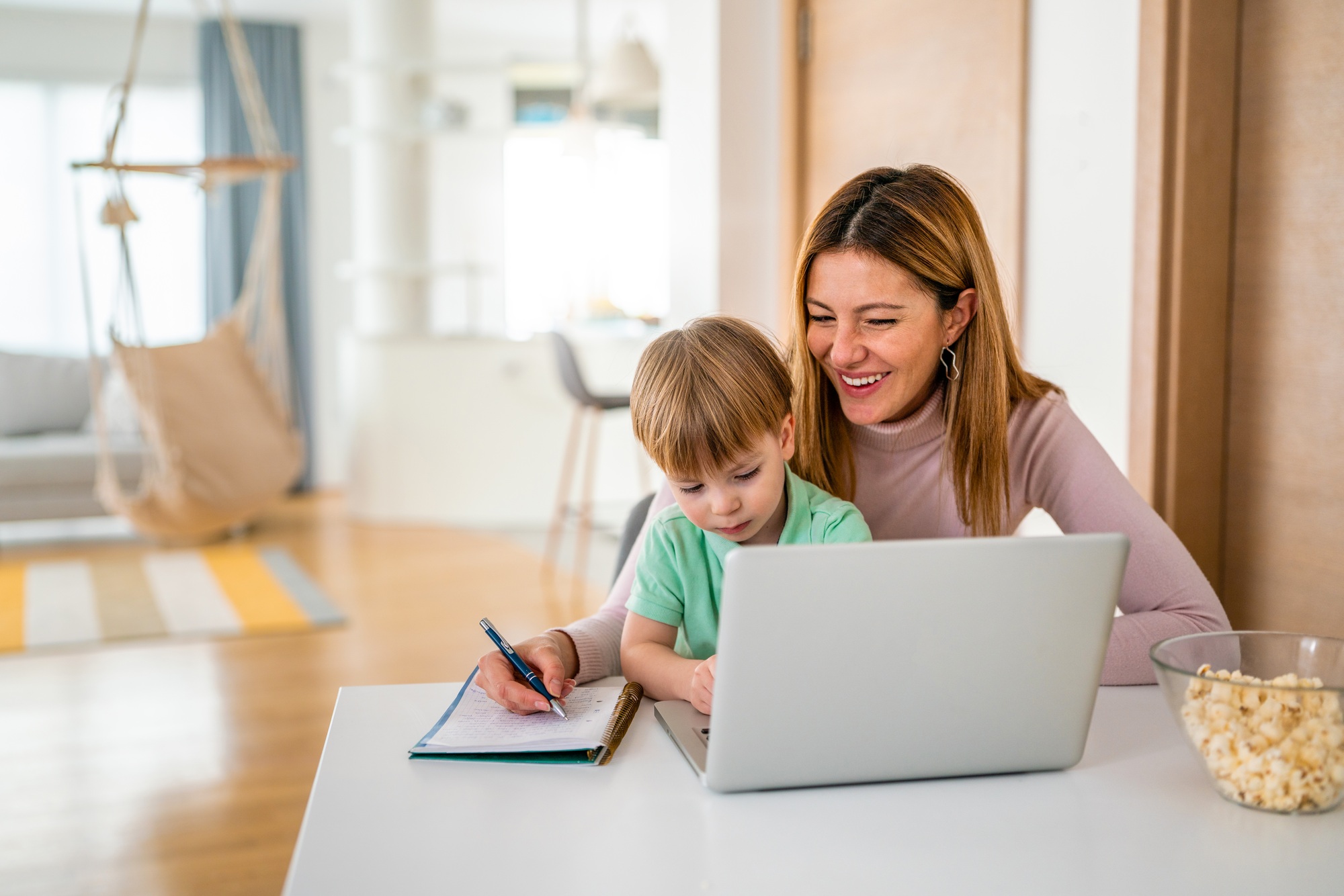 Busy family mother and child at home working on the computer