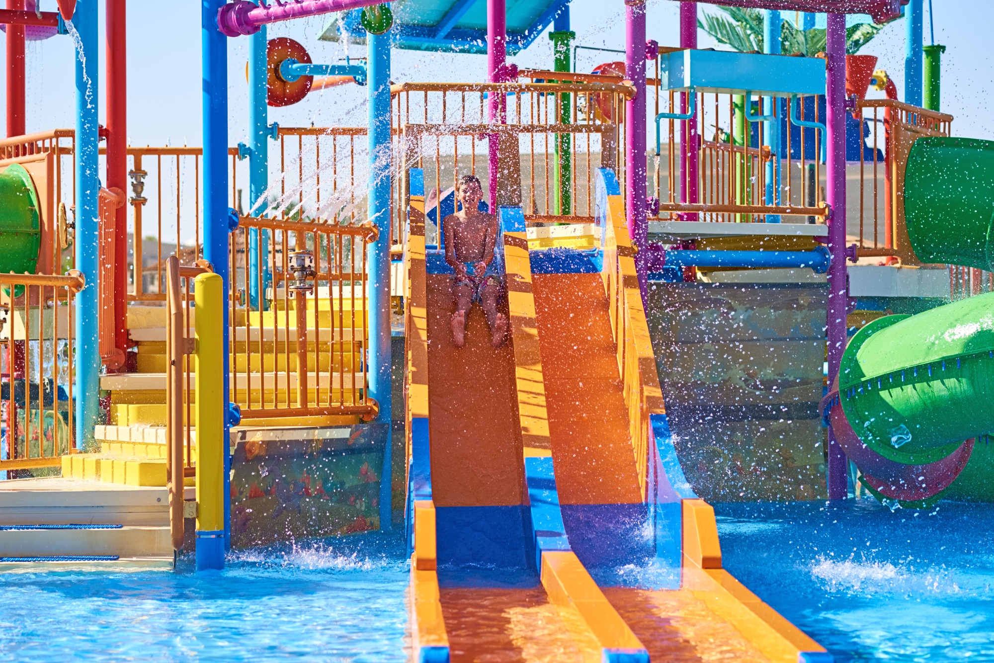 Colorful slides in the waterpark close up. Aquapark sliders with pool
