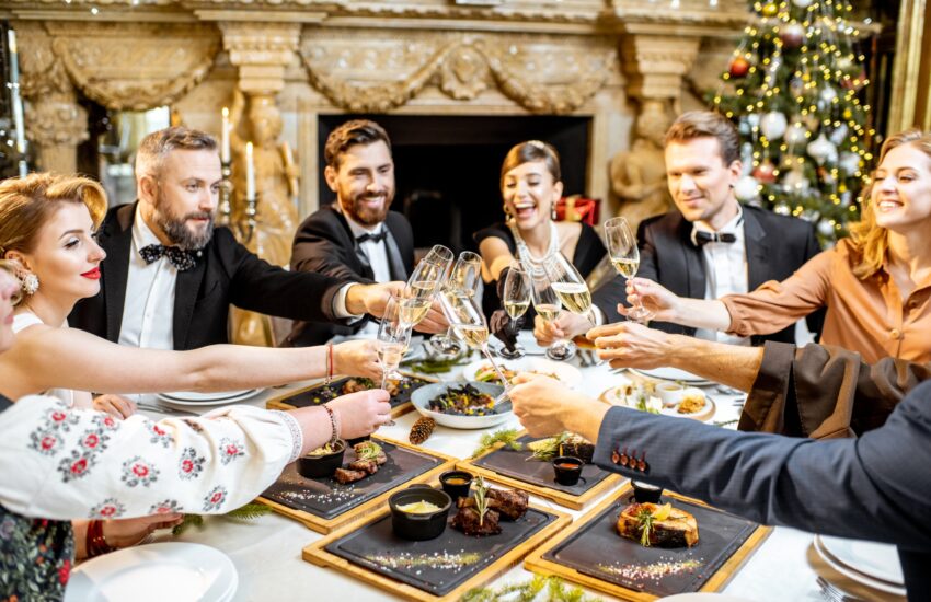 Elegantly dressed people celebrating New Year holiday indoors