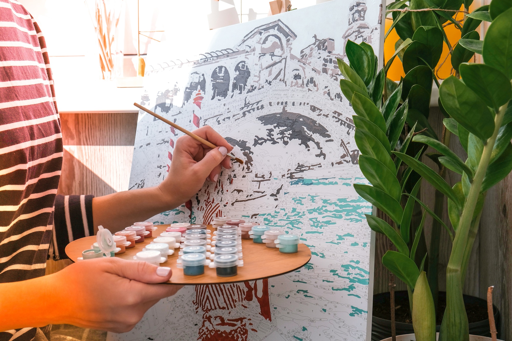Female hands coloring canvas Picture by numbers Creative hobby. Painting for beginners. Leisure acti