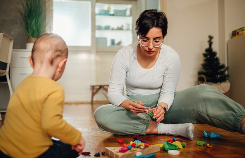 Mother and son molding a clay at home and having educational act