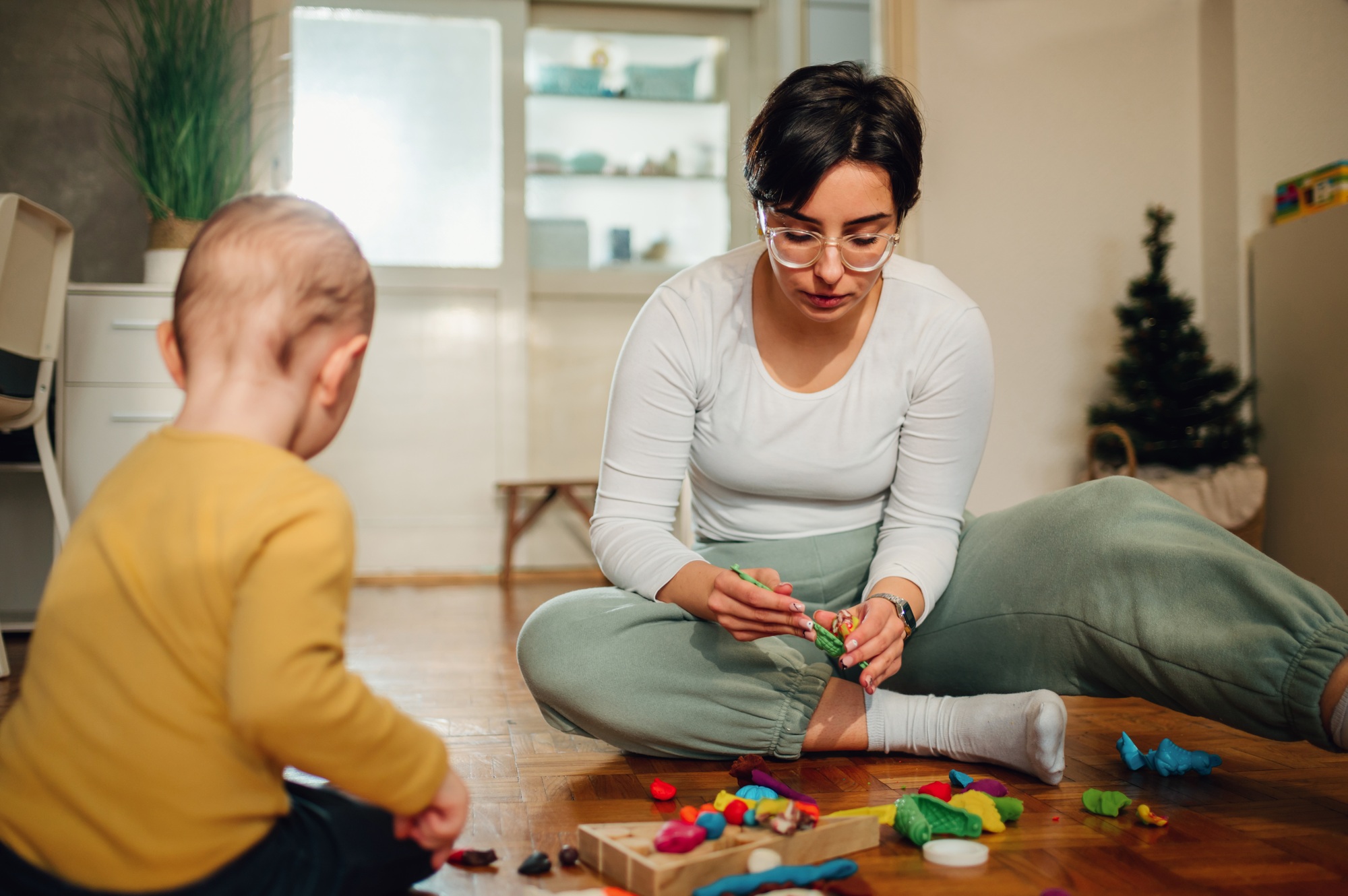 Mother and son molding a clay at home and having educational act
