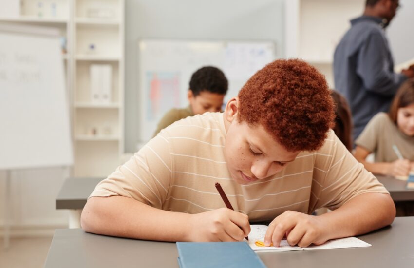 Red Haired Boy Studying in School