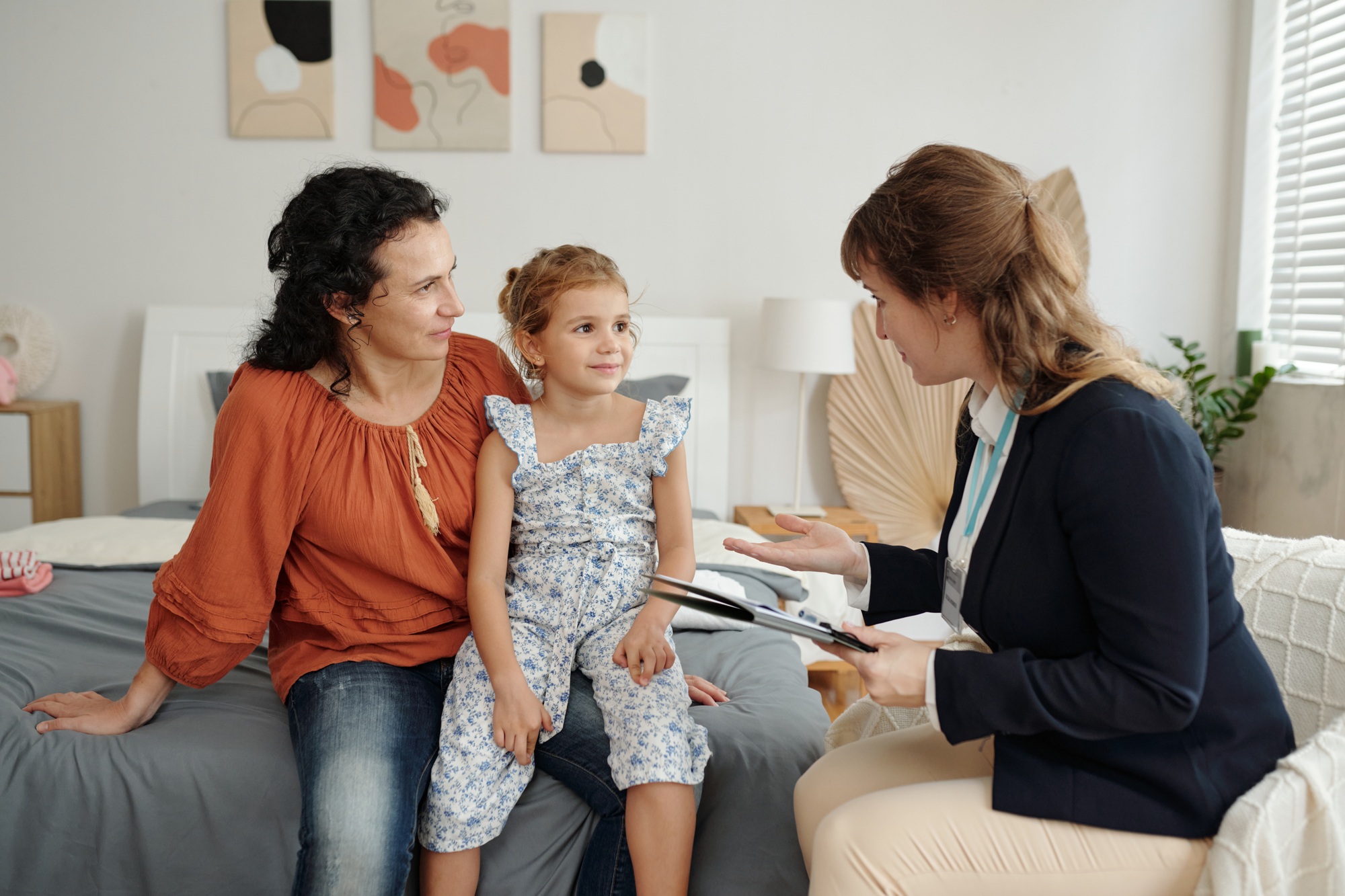Social Worker Working With Adoptive Family At Home